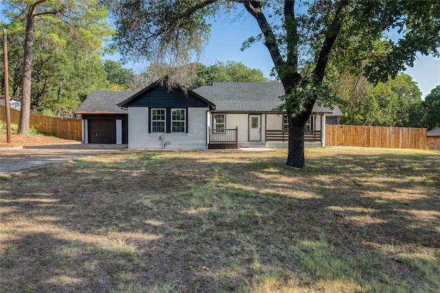 ranch-style house with a garage and a front lawn