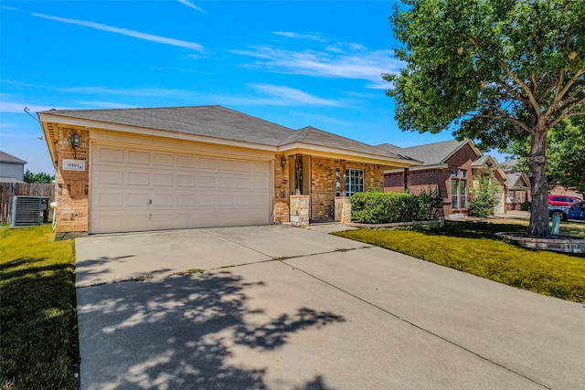 single story home featuring a garage, central air condition unit, and a front yard