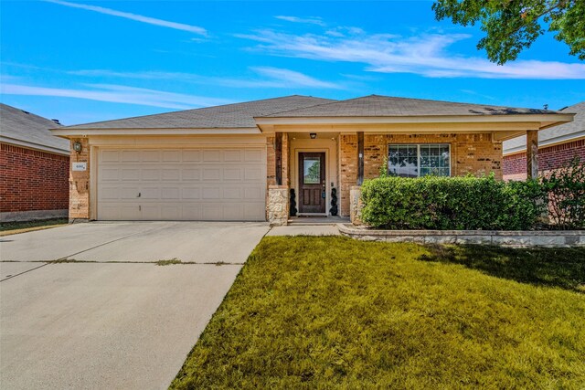 view of front of house with a garage, a front lawn, and covered porch