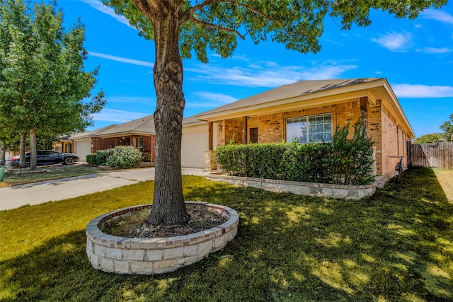 ranch-style house featuring a garage and a front lawn