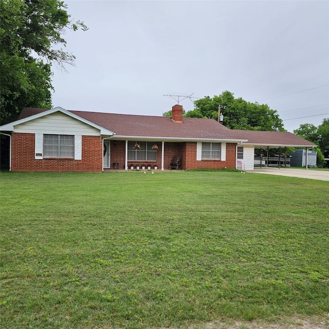 ranch-style home featuring a front yard and a carport