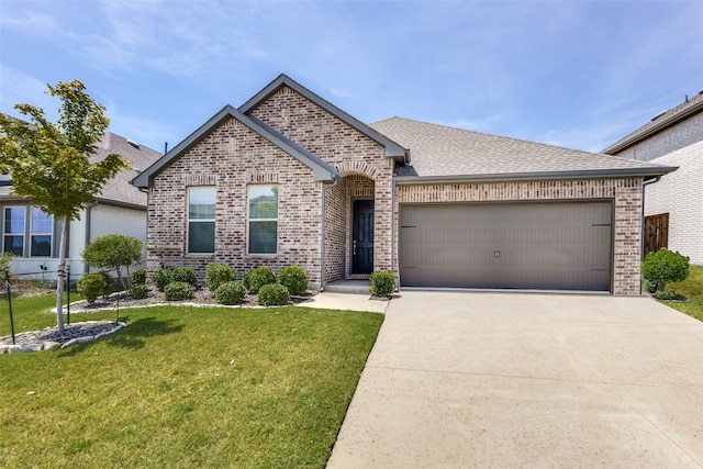 view of front of property featuring a front yard and a garage