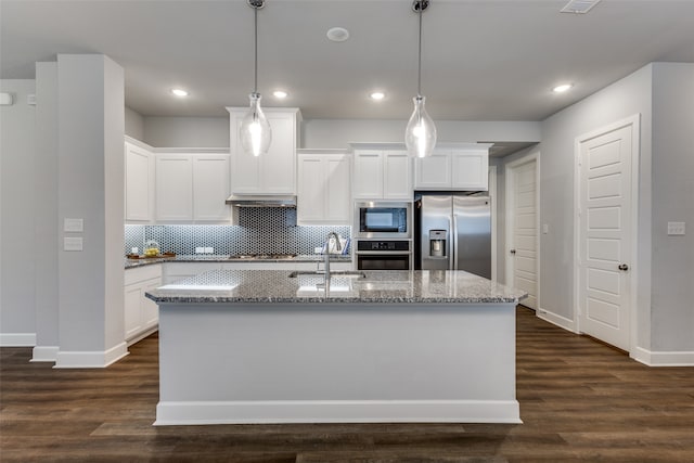 kitchen with appliances with stainless steel finishes, white cabinetry, a kitchen island with sink, dark hardwood / wood-style floors, and extractor fan