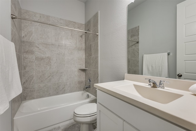 full bathroom featuring vanity, toilet, and tiled shower / bath