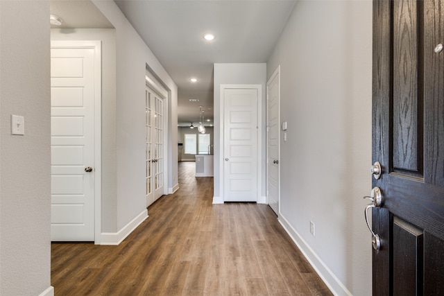 hallway with hardwood / wood-style floors and french doors