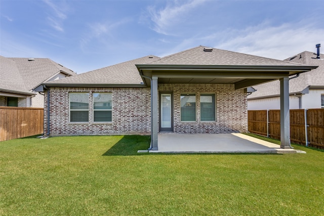 back of property featuring a patio and a yard