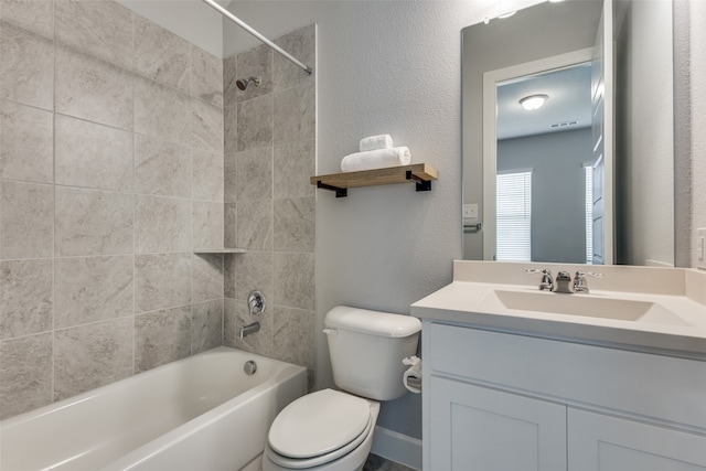 full bathroom featuring tiled shower / bath combo, vanity, and toilet