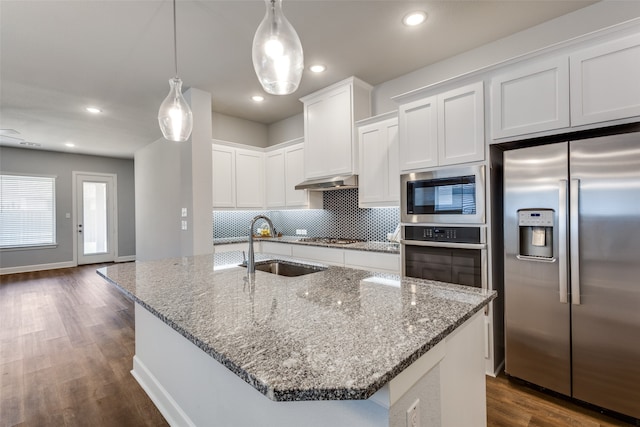 kitchen featuring white cabinets, stainless steel appliances, decorative light fixtures, a kitchen island with sink, and dark hardwood / wood-style floors