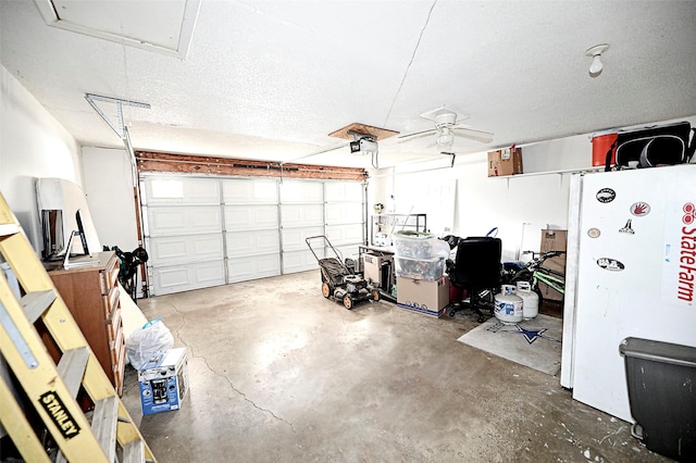 garage featuring white refrigerator and a garage door opener