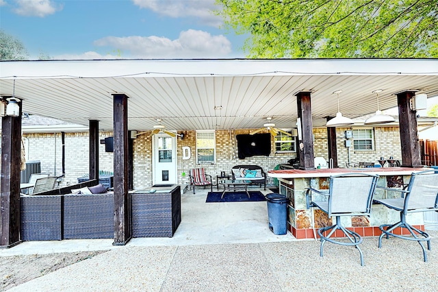 view of patio with outdoor lounge area and exterior bar