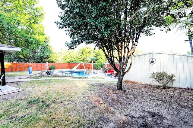 view of yard with a fenced in pool