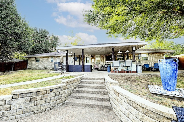 view of front of house featuring an outdoor bar and a patio area