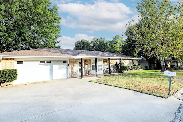 ranch-style house featuring a garage and a front yard