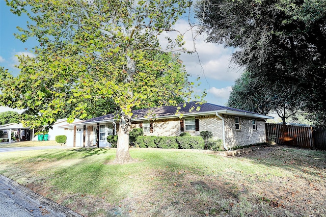 single story home featuring a garage and a front lawn