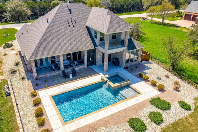 view of pool featuring a lawn, an in ground hot tub, and a patio