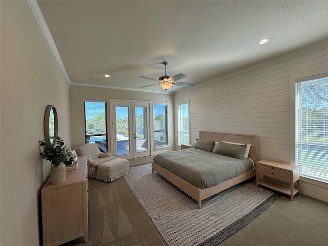 bedroom featuring carpet flooring, access to exterior, ceiling fan, and wood walls