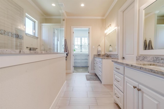 bathroom with tile patterned flooring, crown molding, and vanity