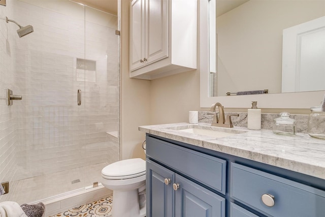 bathroom with toilet, a shower with shower door, and vanity