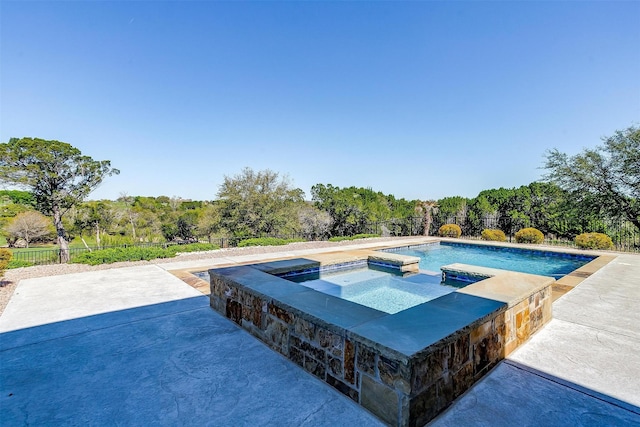 view of swimming pool featuring an in ground hot tub and a patio