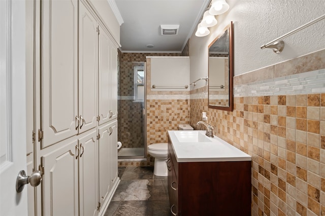 bathroom featuring toilet, an enclosed shower, ornamental molding, vanity, and tile walls