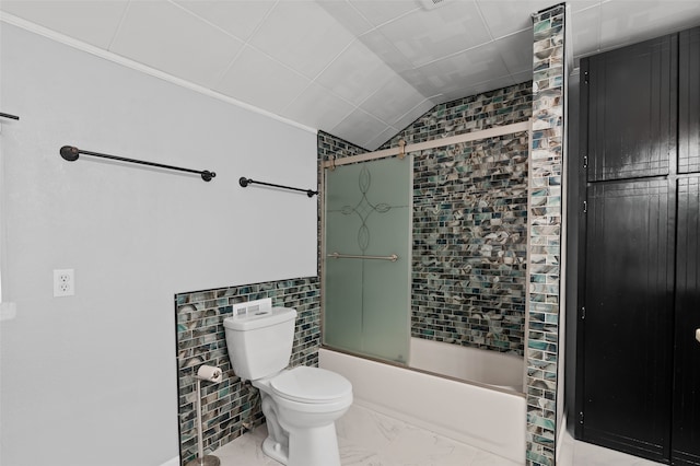 bathroom with tiled shower / bath combo, vaulted ceiling, toilet, and tile walls