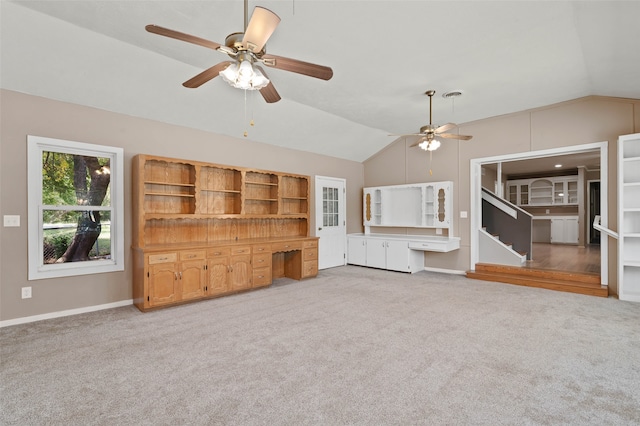 unfurnished living room with lofted ceiling, ceiling fan, and carpet floors