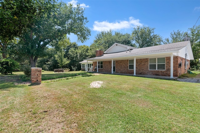 view of side of property with a lawn