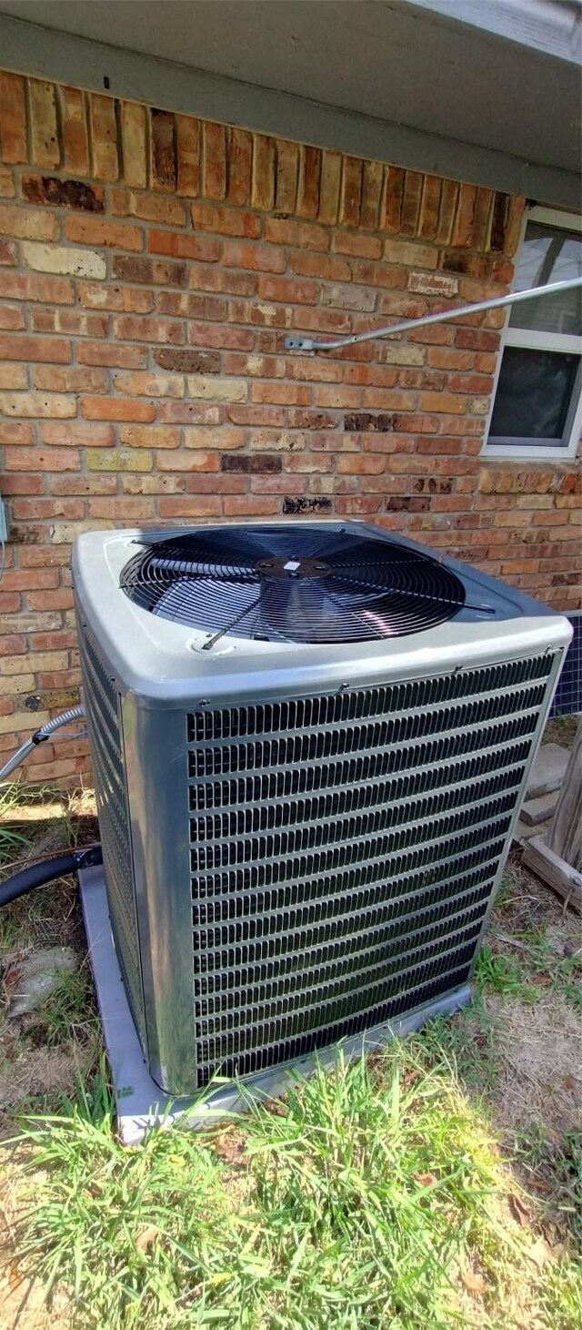 1400 Sherman Dr, Whitesboro, TX 76273 - exterior view of central air condition unit and brick siding