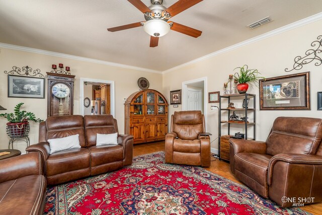 living room featuring ceiling fan, hardwood / wood-style floors, and ornamental molding