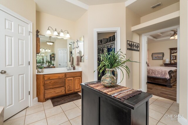 bathroom featuring tile patterned floors, vanity, and crown molding