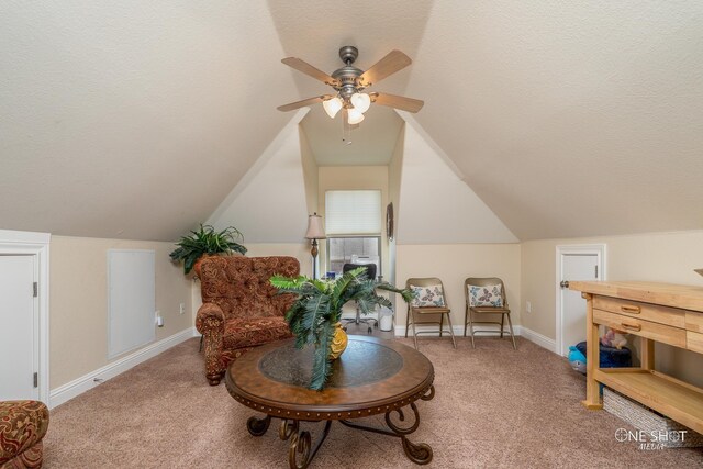 sitting room with carpet flooring, ceiling fan, lofted ceiling, and a textured ceiling