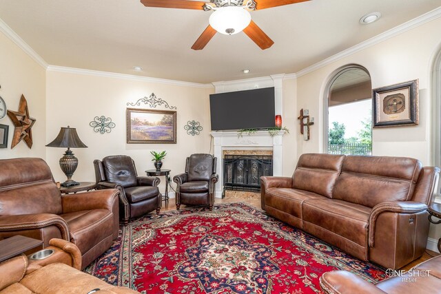 living room with ceiling fan and crown molding