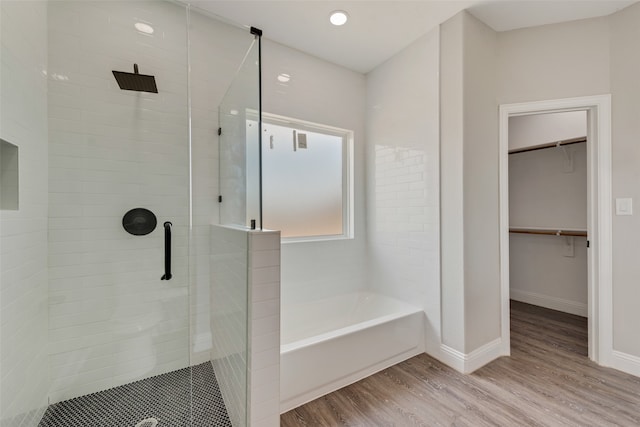 bathroom featuring hardwood / wood-style floors and separate shower and tub