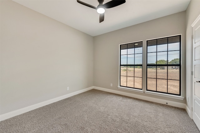 carpeted empty room featuring ceiling fan