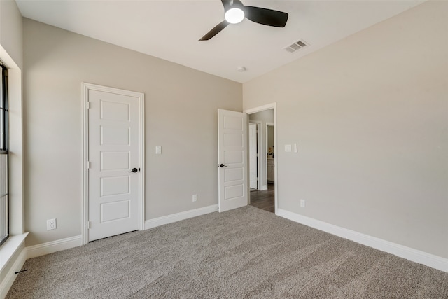 unfurnished bedroom with ceiling fan and carpet