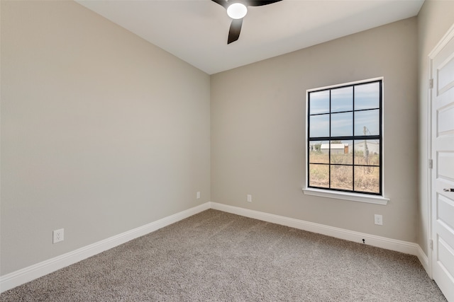 carpeted spare room with ceiling fan