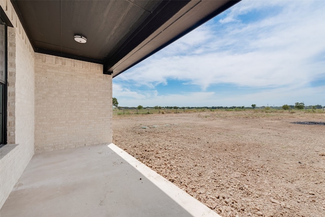 view of yard with a rural view