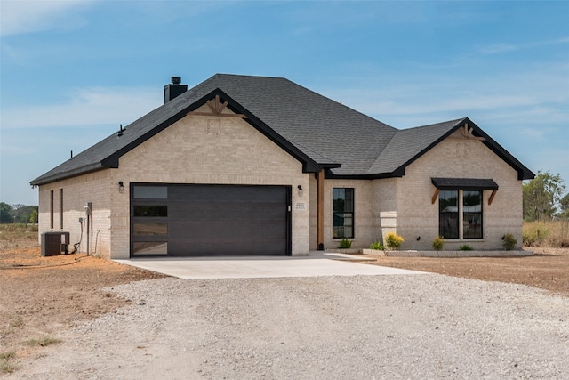 view of front facade featuring central AC and a garage