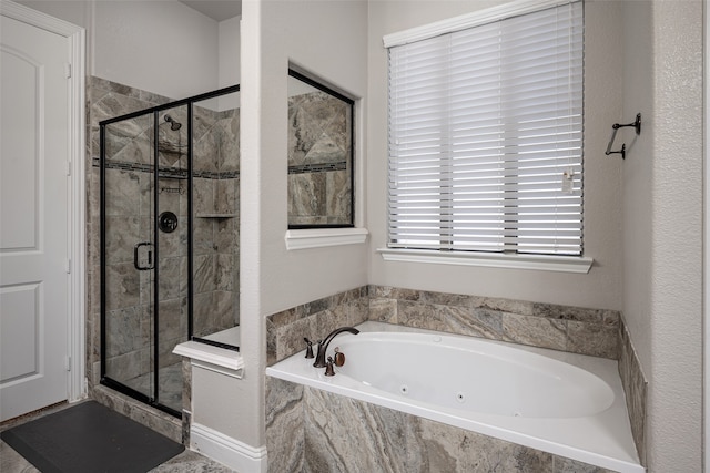 bathroom featuring shower with separate bathtub