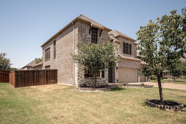 view of front facade featuring a front lawn and a garage