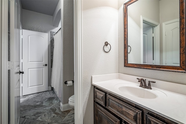 bathroom with tile patterned flooring, toilet, and vanity