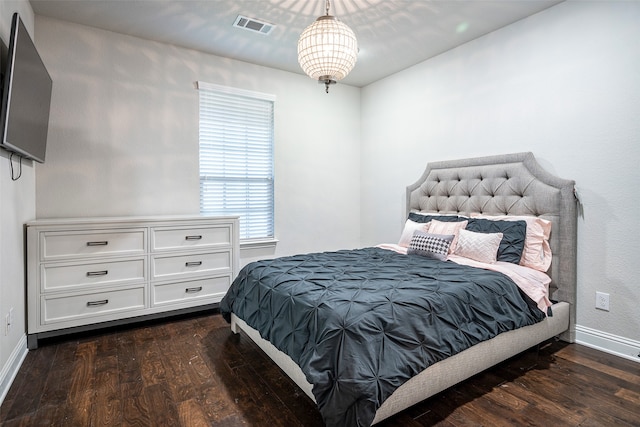 bedroom with dark hardwood / wood-style floors