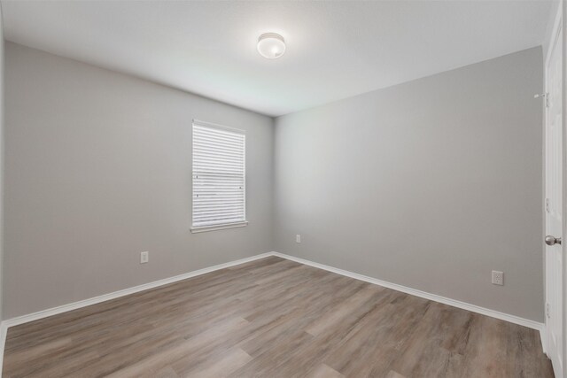 spare room featuring hardwood / wood-style flooring