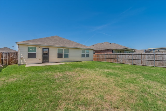 rear view of house with a patio area and a yard