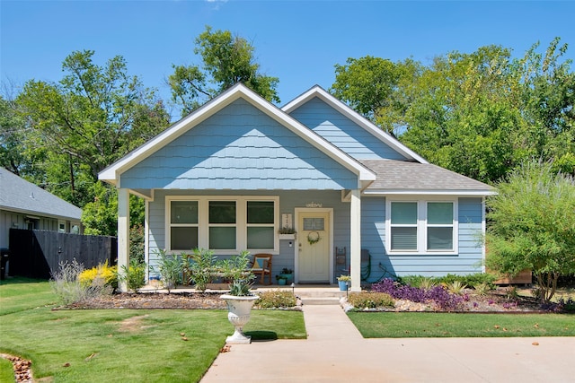 bungalow with a front lawn and covered porch