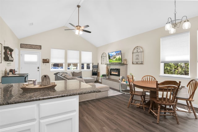 kitchen with dark hardwood / wood-style floors, pendant lighting, ceiling fan with notable chandelier, white cabinets, and dark stone countertops