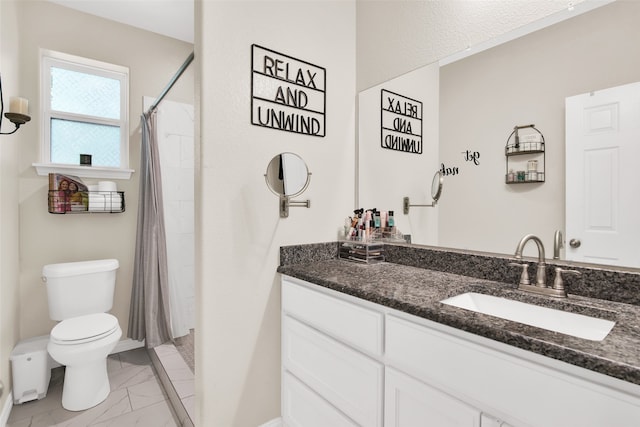 bathroom featuring tile patterned floors, vanity, and toilet