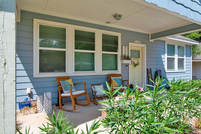 view of exterior entry featuring a patio area