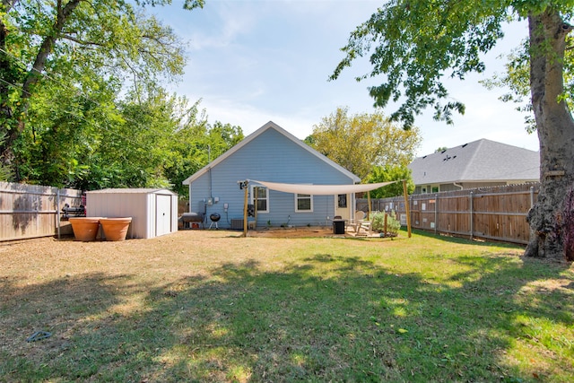 rear view of house featuring a yard and a shed