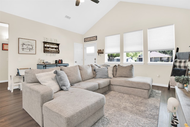 living room with ceiling fan, high vaulted ceiling, and dark wood-type flooring